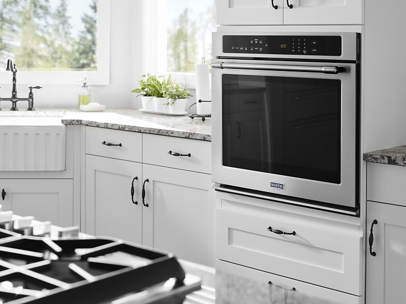 Maytag® in-wall oven in a bright, white kitchen