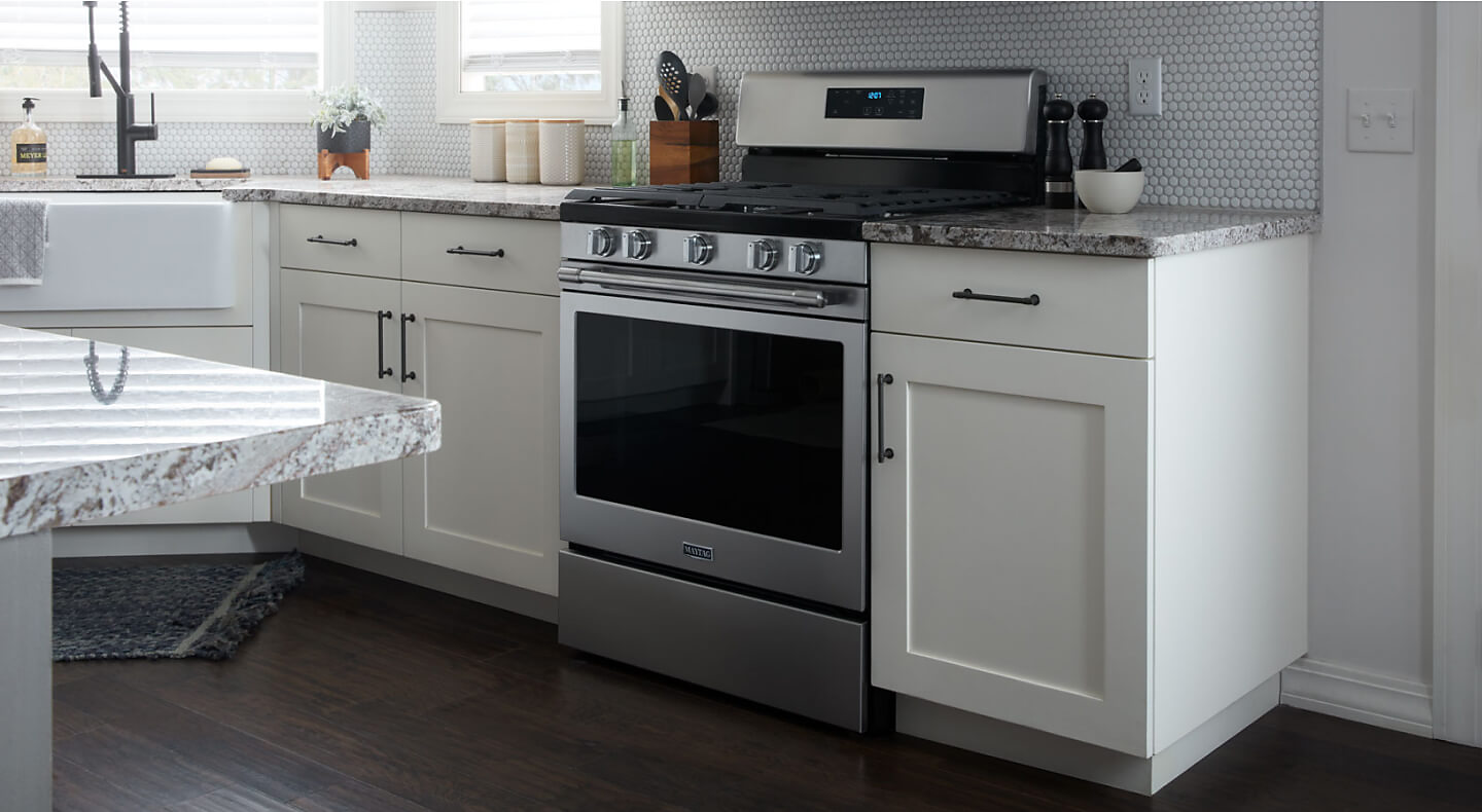 Maytag® range set in white cabinetry