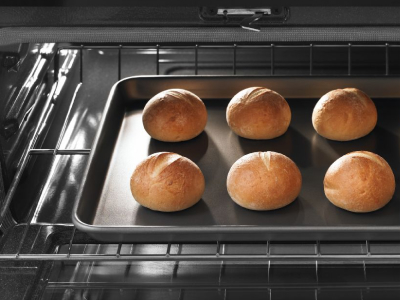 Oven light on with rolls on cookie sheet