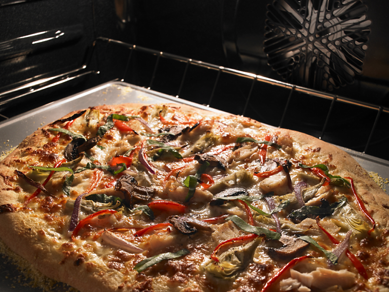 Pizza cooking inside a Maytag® oven