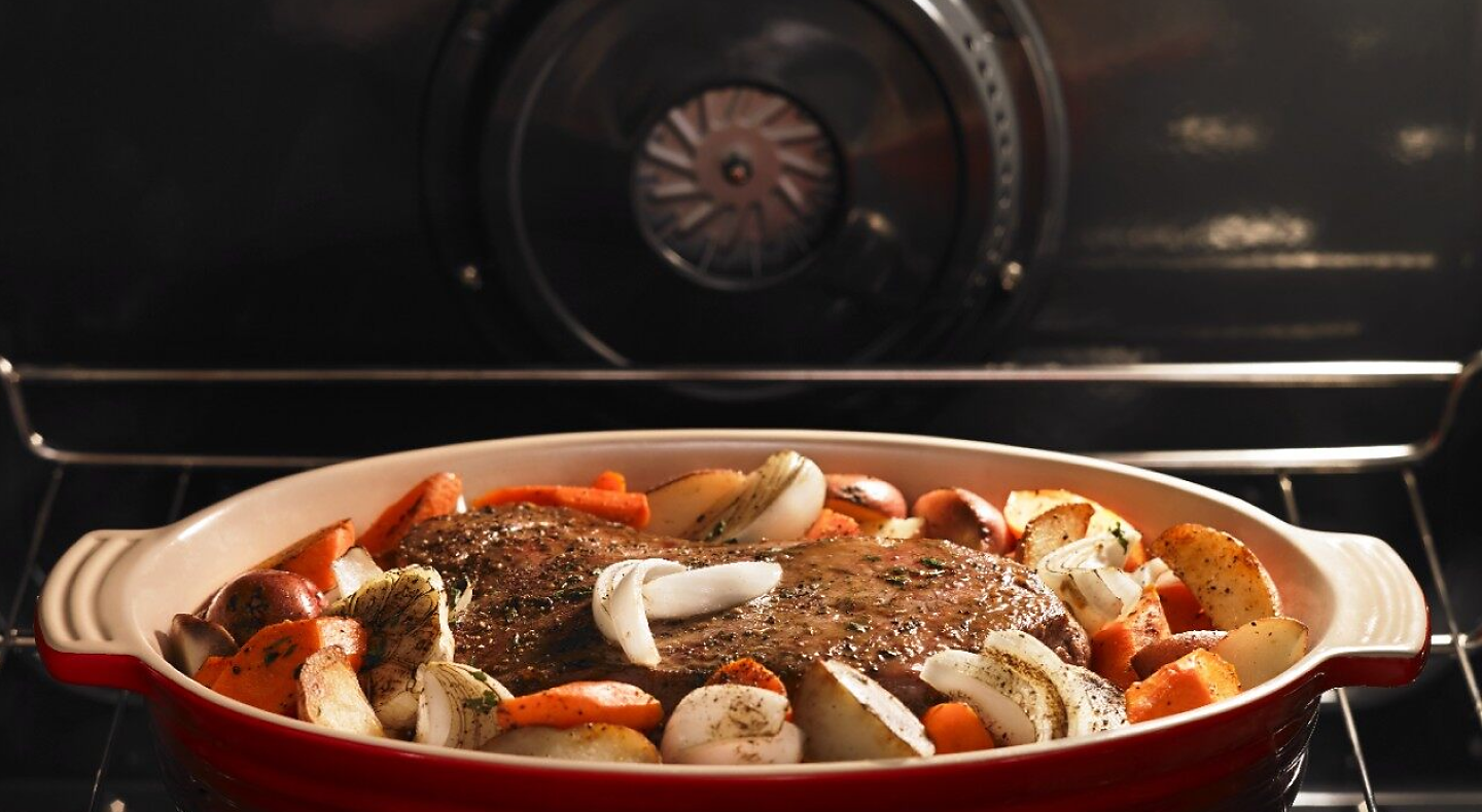 Pot roast and vegetables cooking inside a Maytag® oven