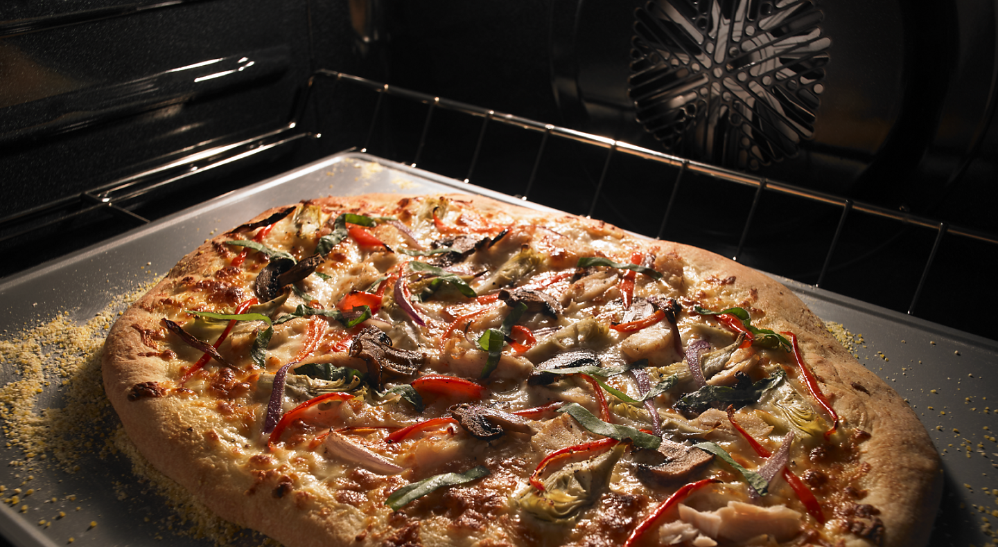 Pizza cooking inside a Maytag® oven