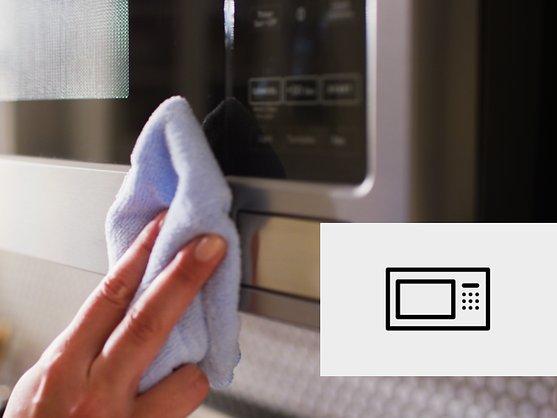 Cleaning the exterior of a microwave.