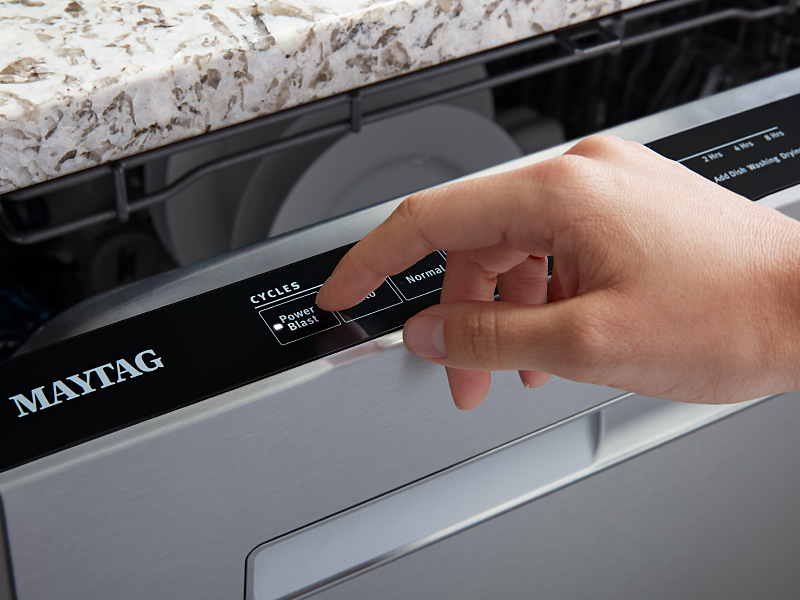 Person selecting the PowerBlast® cycle on a Maytag® dishwasher