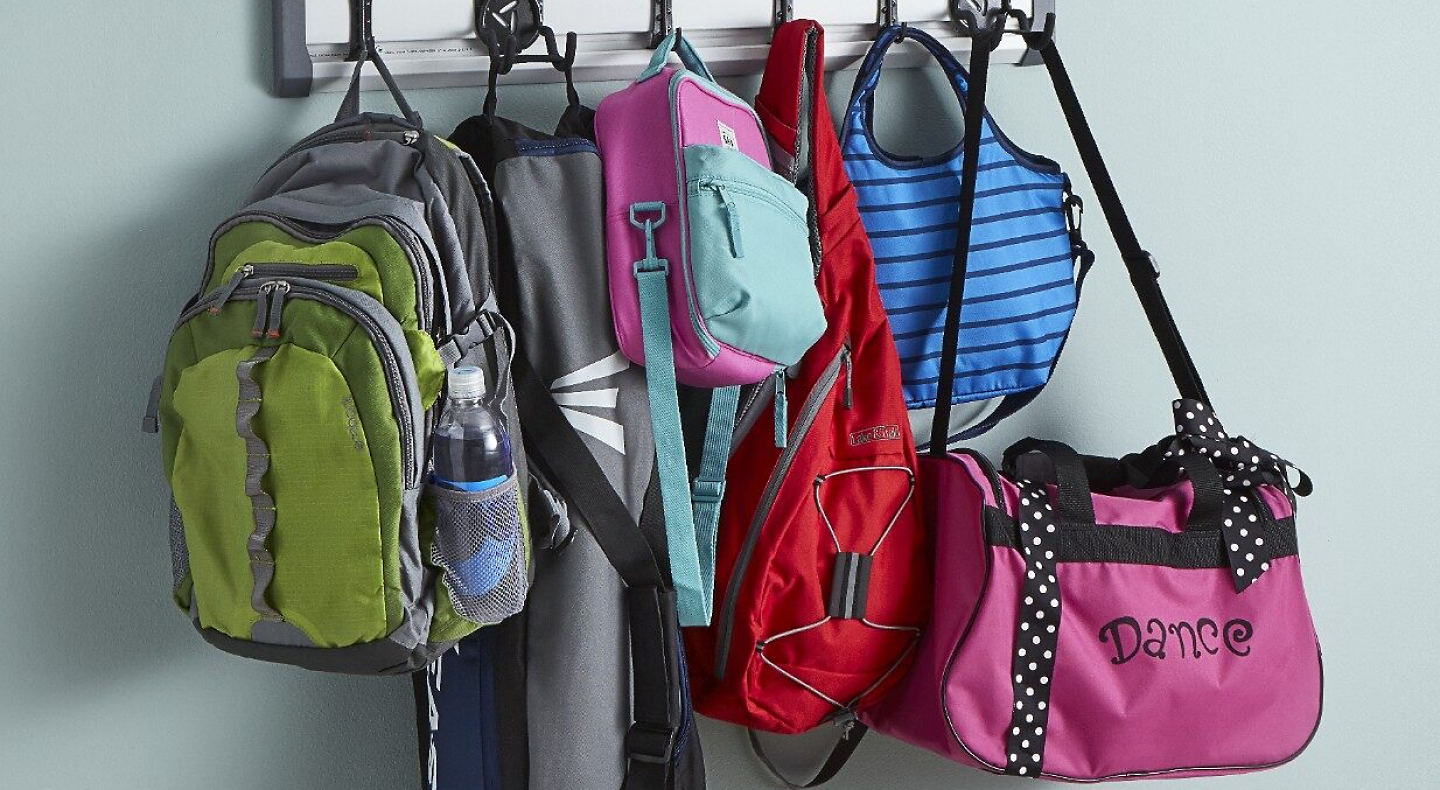 A closeup of a coat rack bags and backpacks.