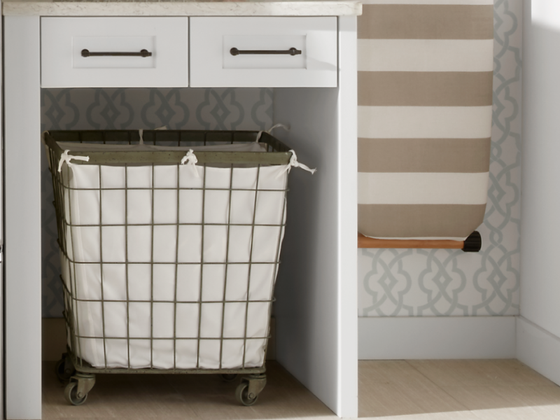 A laundry basket next to a Maytag® dryer in a modern laundry room.