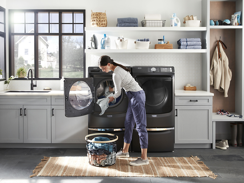 Person taking laundry out of a Maytag® front load washer