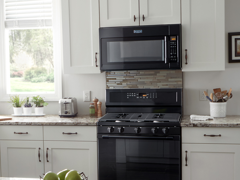 A Maytag® over-the-range microwave in a modern kitchen. 
