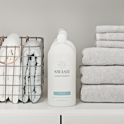 Swash™ detergent bottle in a laundry cabinet
