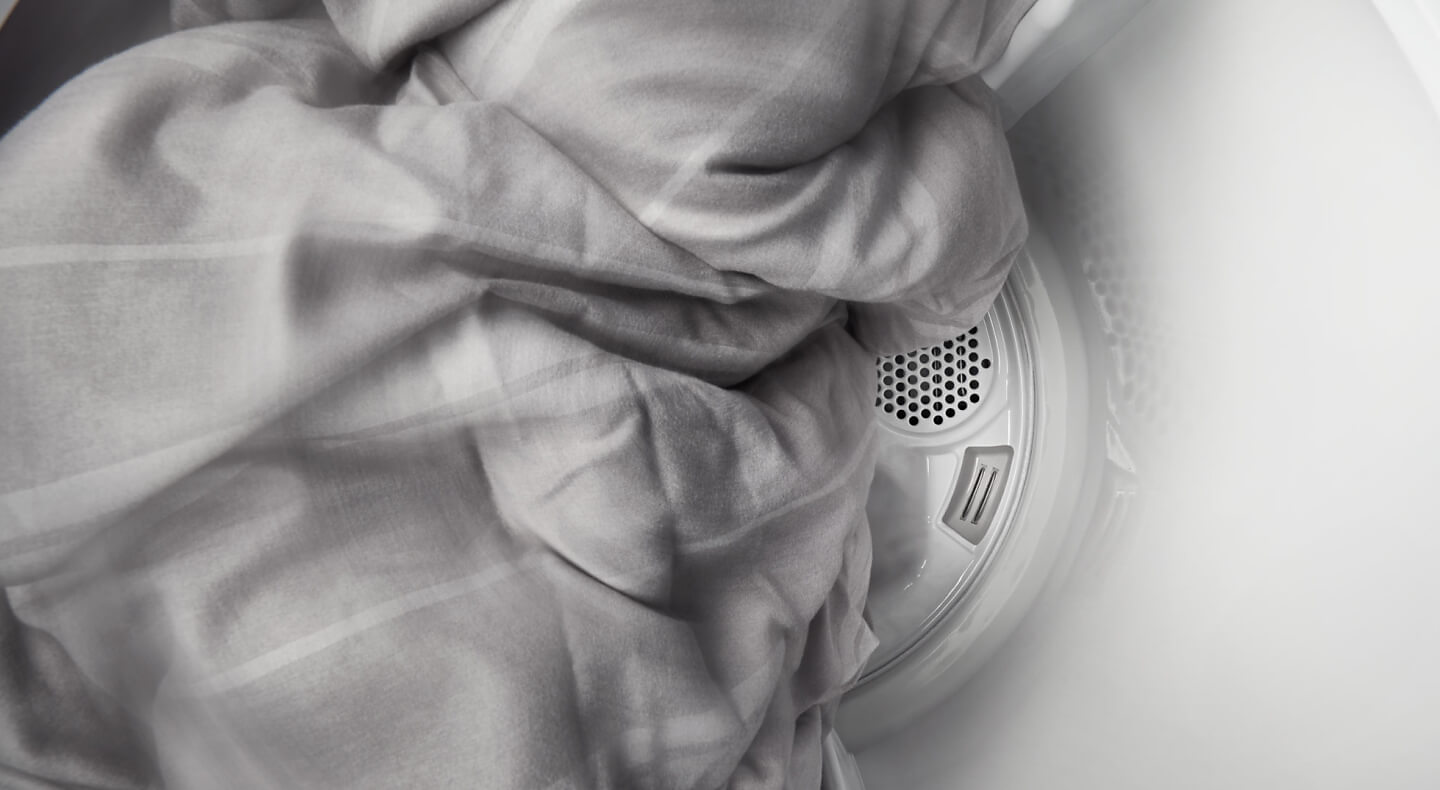 Sheets tumbling in a Maytag® dryer.