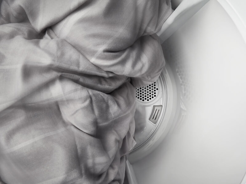 Sheets tumbling in a Maytag® dryer.
