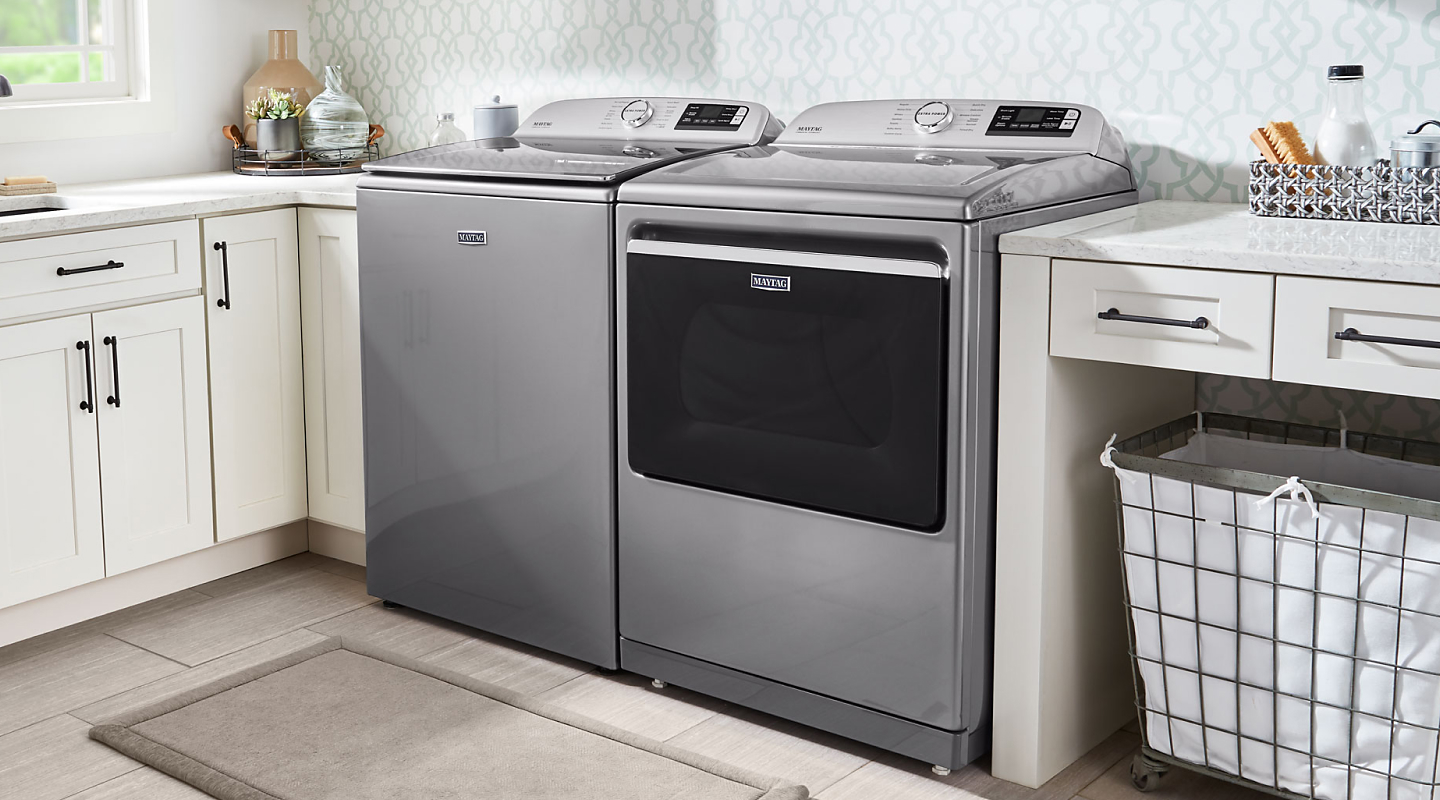 Maytag® top loading washer and dryer in a laundry room Maytag® top loading washer and dryer in a laundry room