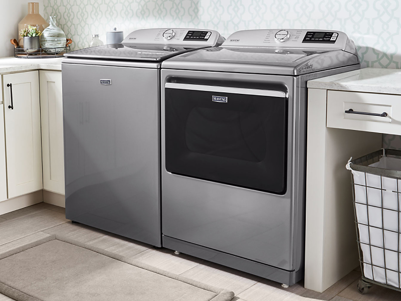 Maytag® top loading washer and dryer in a laundry room