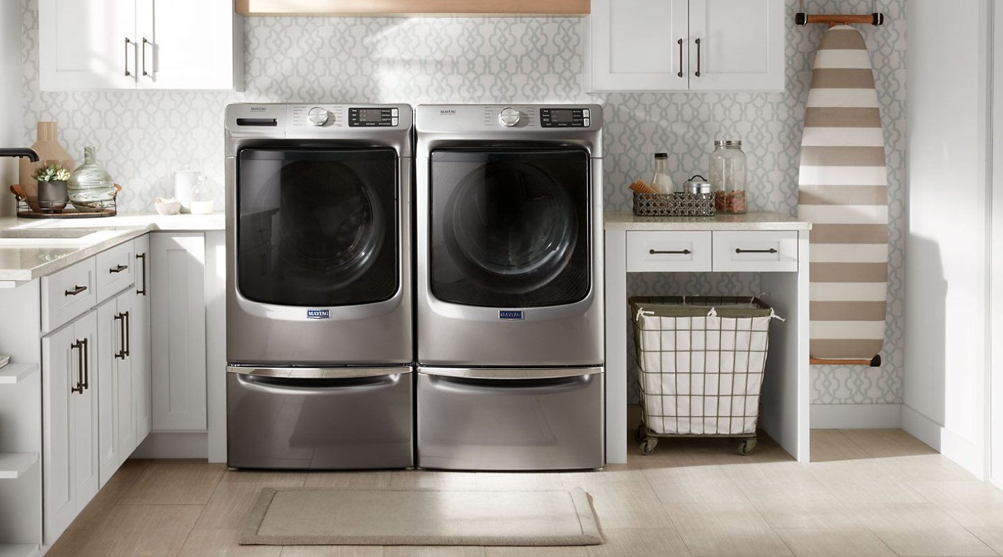 Maytag® front loading washer and dryer in a laundry room