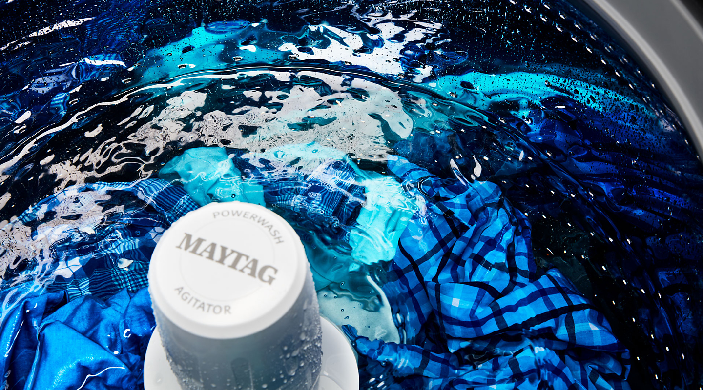Clothes in a wash cycle inside a Maytag® top load washer Clothes in a wash cycle inside a Maytag® top load washer