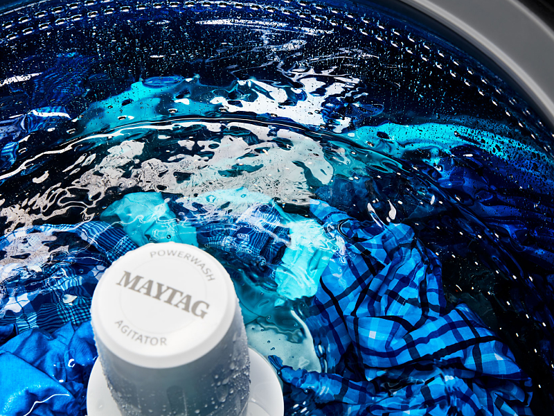 Clothes in a wash cycle inside a Maytag® top load washer Clothes in a wash cycle inside a Maytag® top load washer