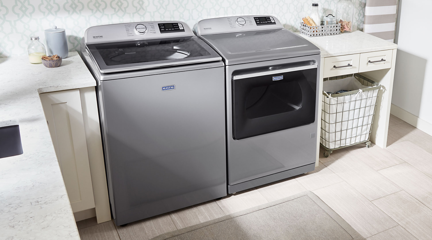 Maytag® top loading washer and dryer in a laundry room Maytag® top loading washer and dryer in a laundry room