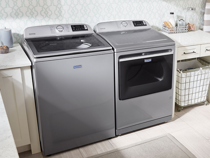 Maytag® top loading washer and dryer in a laundry room Maytag® top loading washer and dryer in a laundry room