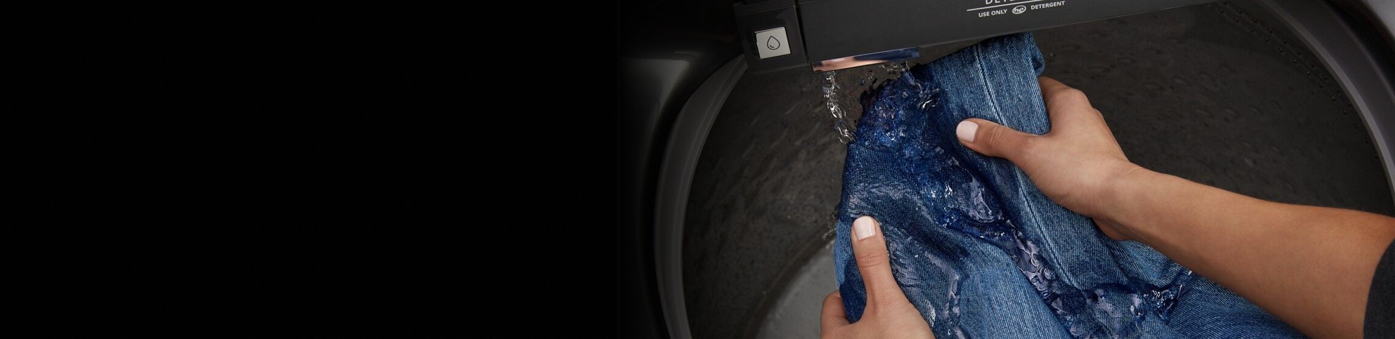 Jeans getting rinsed in the built-in water faucet.