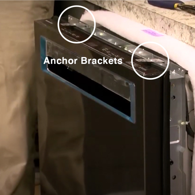 Dishwasher with anchor brackets attached to the top