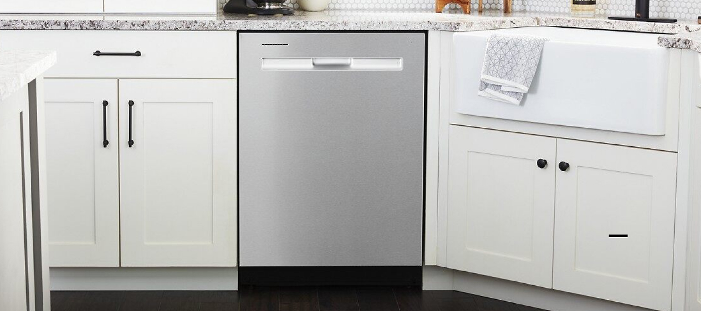 Maytag® dishwasher installed between white kitchen cabinets