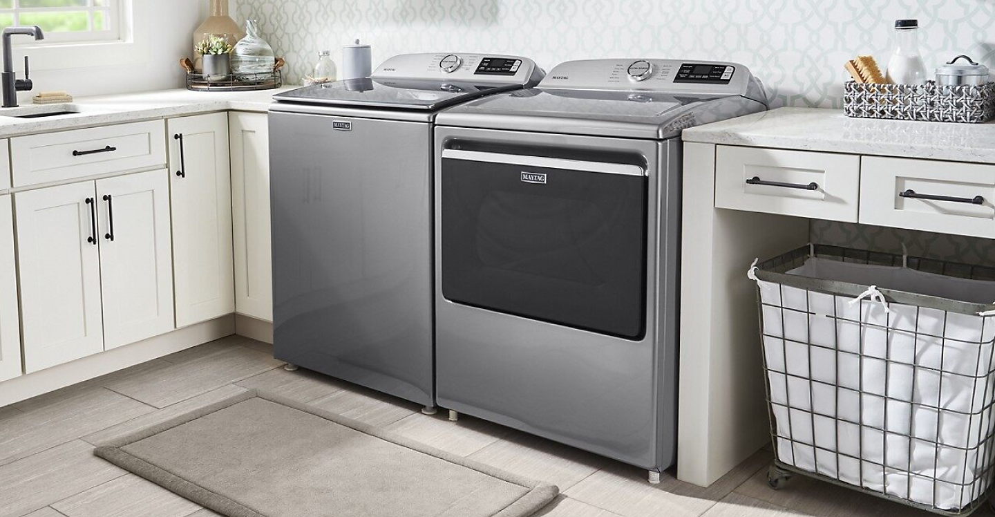 Gray Maytag® washer and dryer pair in white cabinetry