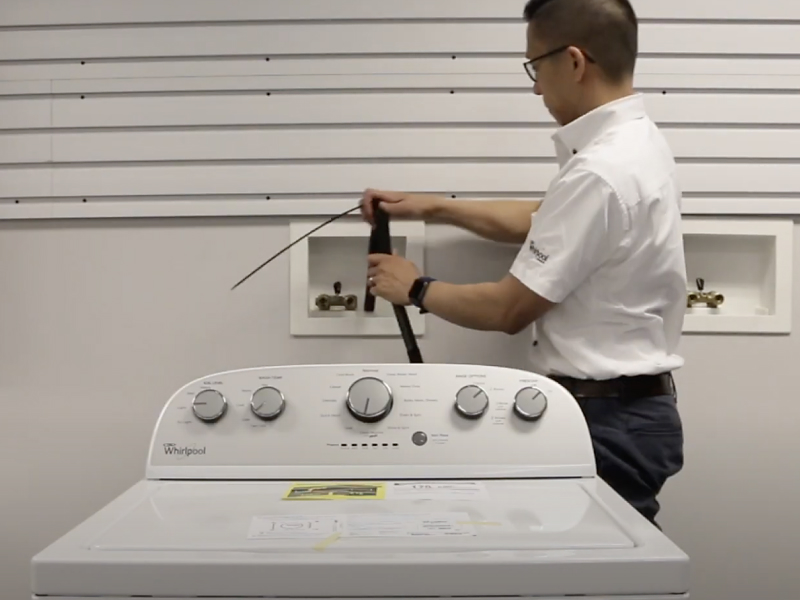 A man placing a drain hose into the standpipe of a Maytag® washing machine. P#: screenshot of video A man placing a drain hose into the standpipe of a Maytag® washing machine. P#: screenshot of video