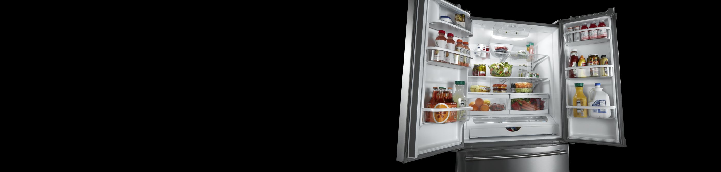 An open French door refrigerator with various food items inside