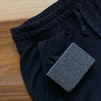 A sweater stone on a pair of sweatpants with fabric pills