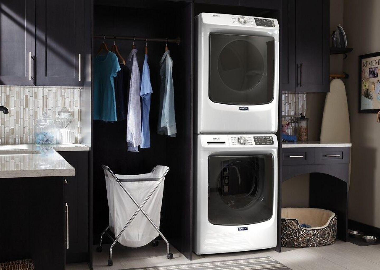 Stacked white Maytag® washer and dryer in laundry room 