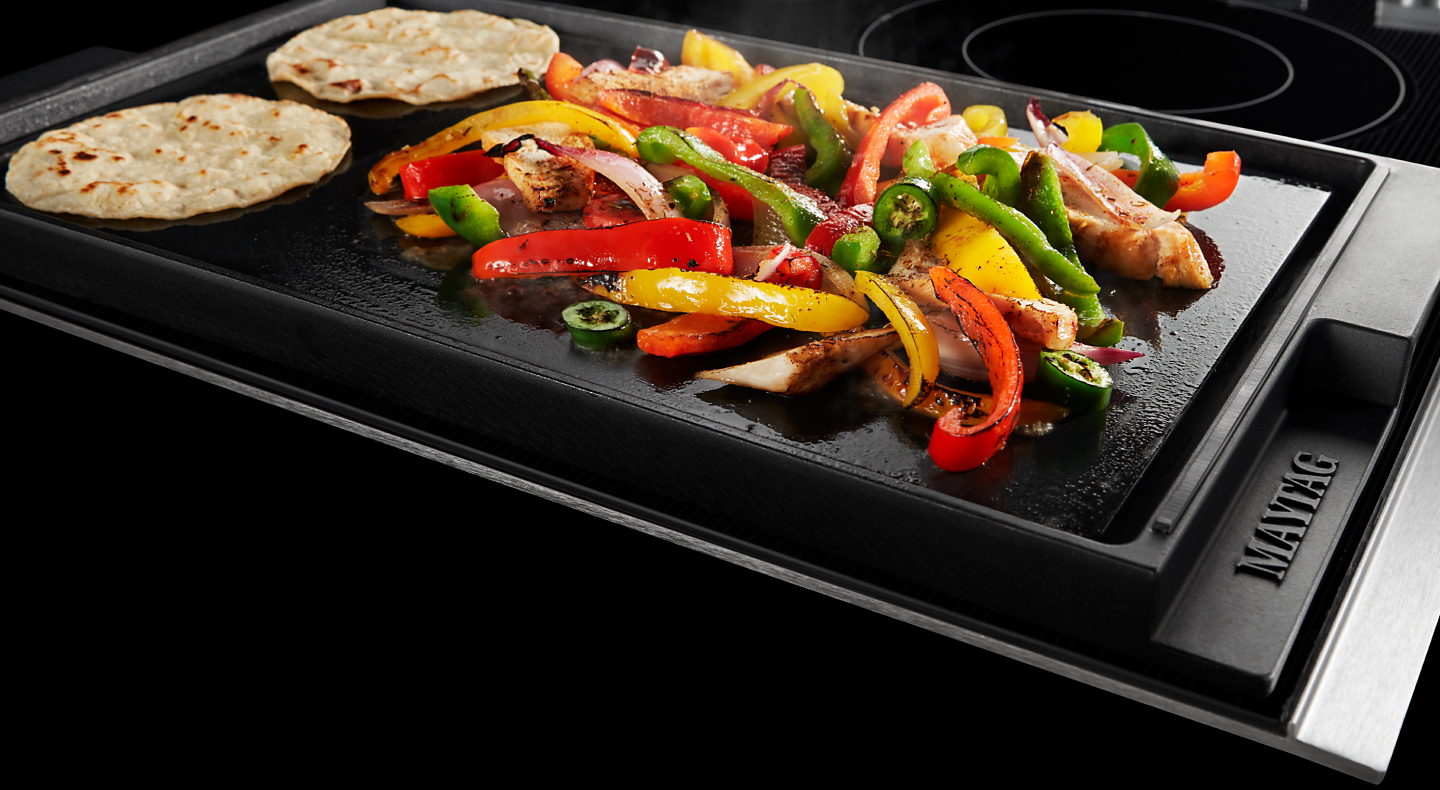 Fajitas cooking on a griddle