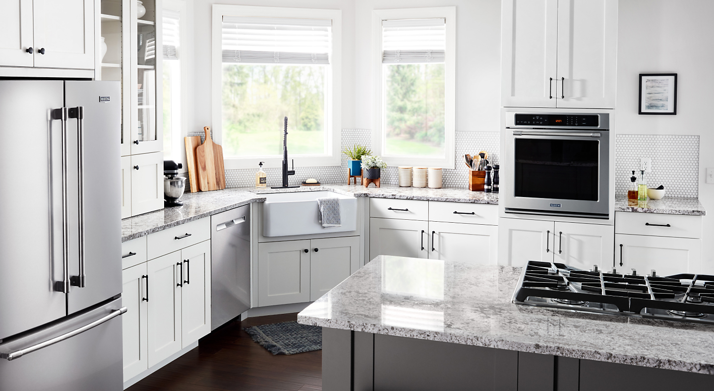 Kitchen with white cabinetry, granite countertops, stainless steel appliances and single wall oven Kitchen with white cabinetry, granite countertops, stainless steel appliances and single wall oven