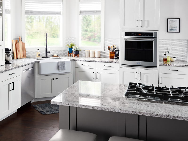 Kitchen with white cabinetry, granite countertops, stainless steel appliances and single wall oven Kitchen with white cabinetry, granite countertops, stainless steel appliances and single wall oven