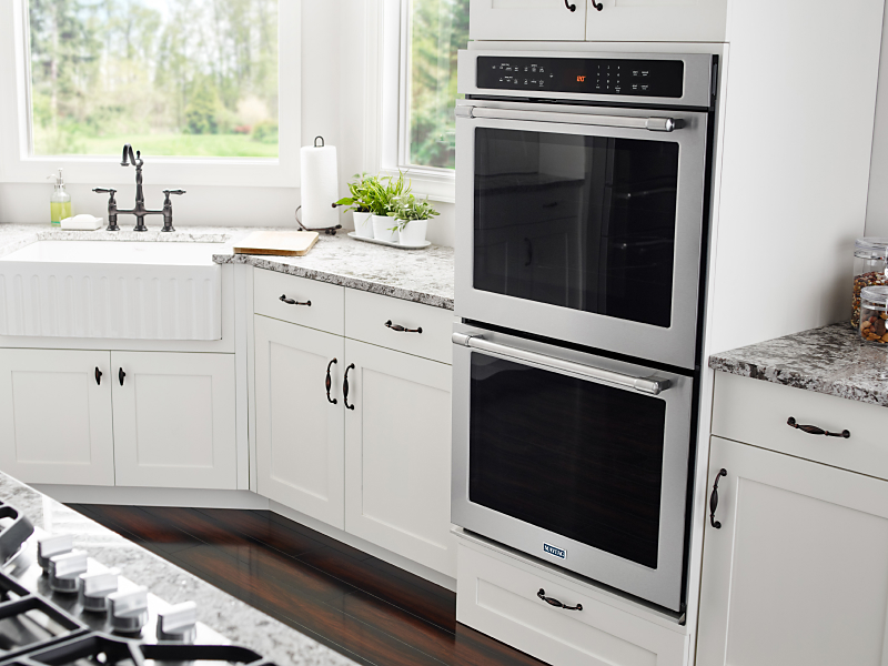 Double wall oven from Maytag brand in kitchen with white cabinetry