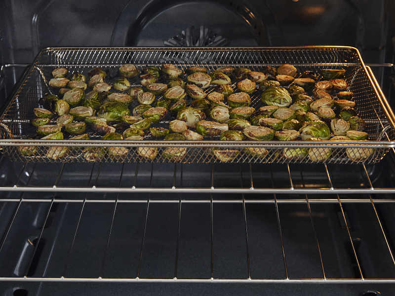 Brussel sprouts cooking in an air frying oven