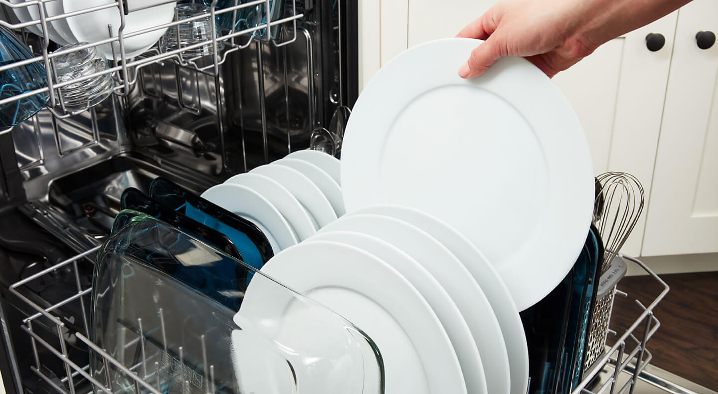 Removing a clean plate from the dishwasher