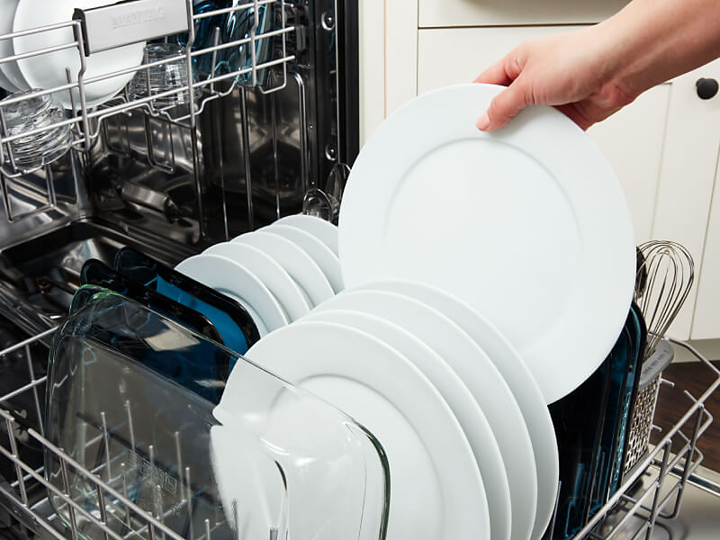 Removing a clean plate from the dishwasher