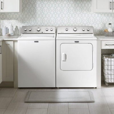 White Maytag® top load washer and dryer set in laundry room 