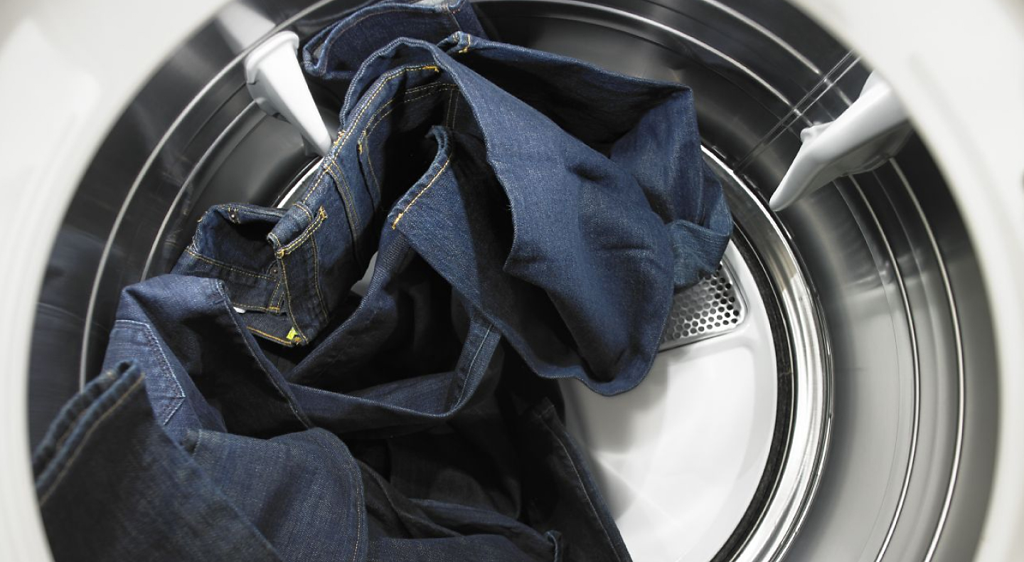 Jeans tumbling inside a dryer
