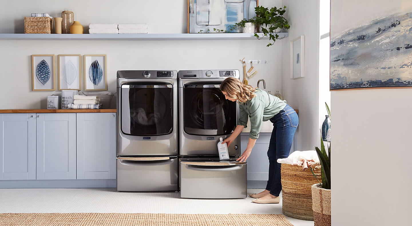 Woman removing product from dryer storage