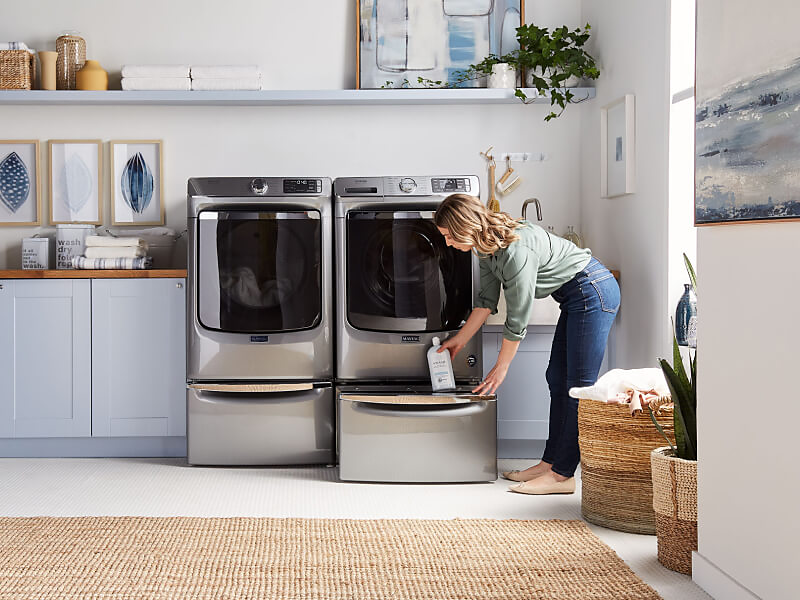 Woman removing product from dryer storage