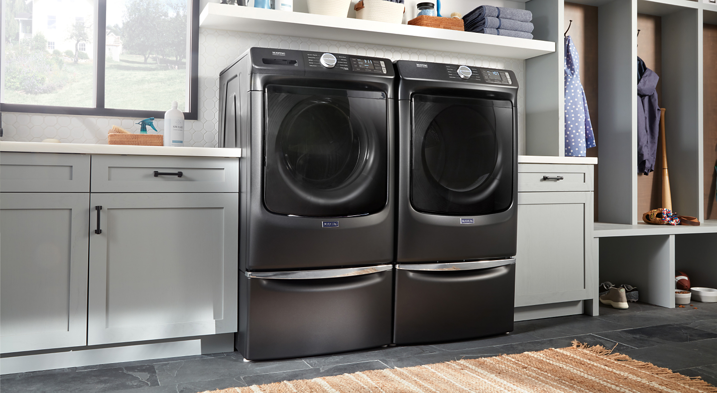 Maytag® front load washer and dryer on laundry pedestals
