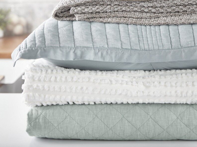Stack of folded blankets and pillows