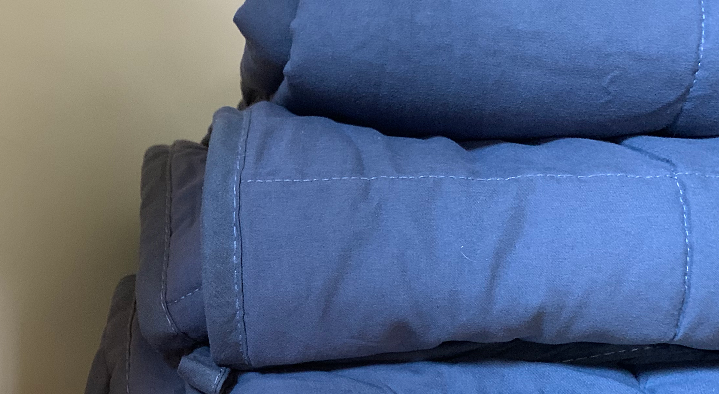 Stack of folded blue comforters
