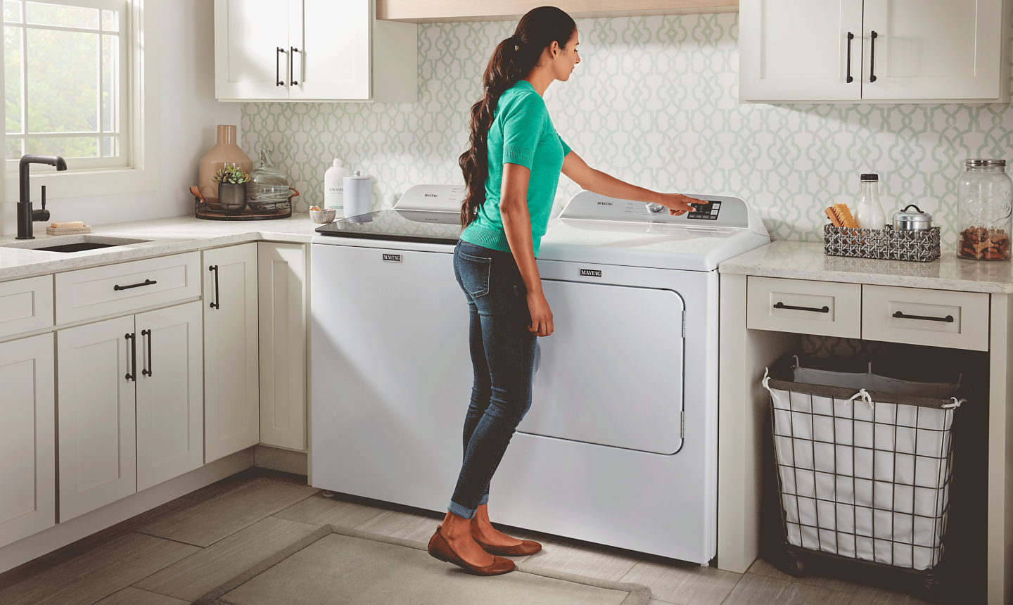 Person using Maytag® dryer in house