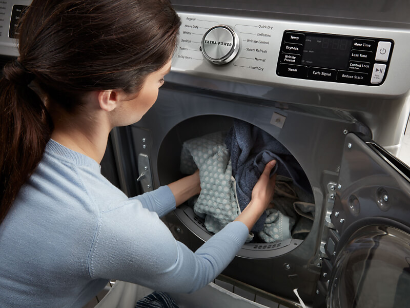 Person emptying a dryer