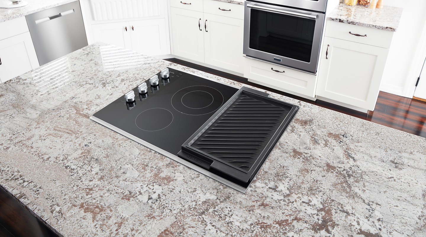  Black induction cooktop with grill pan on gray countertop
