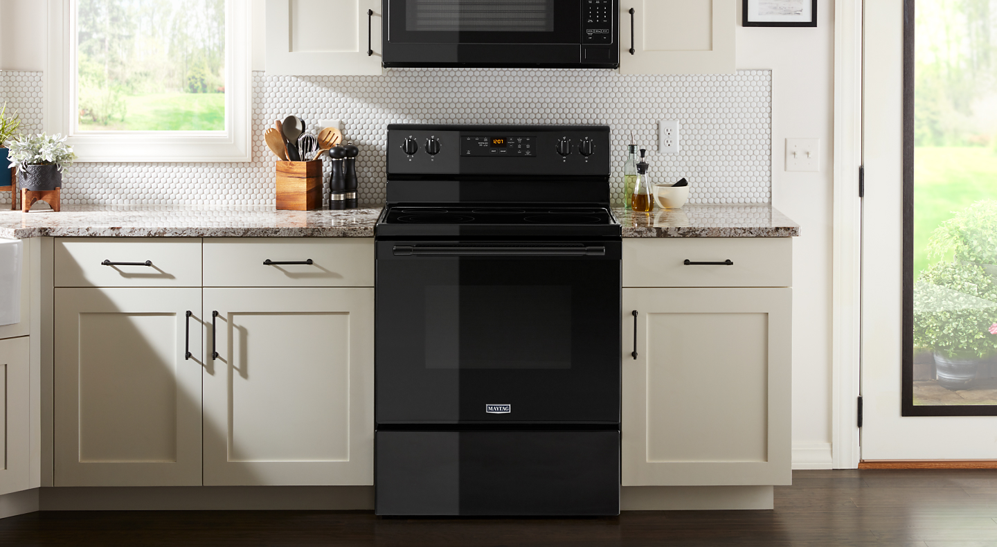 A kitchen layout featuring a Maytag® electric range