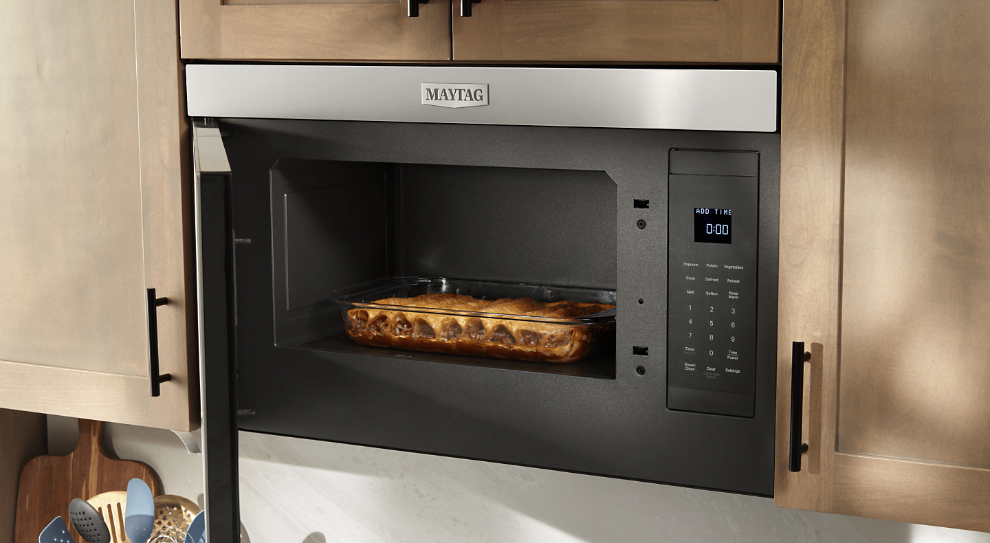 A Maytag® convection microwave baking a meal