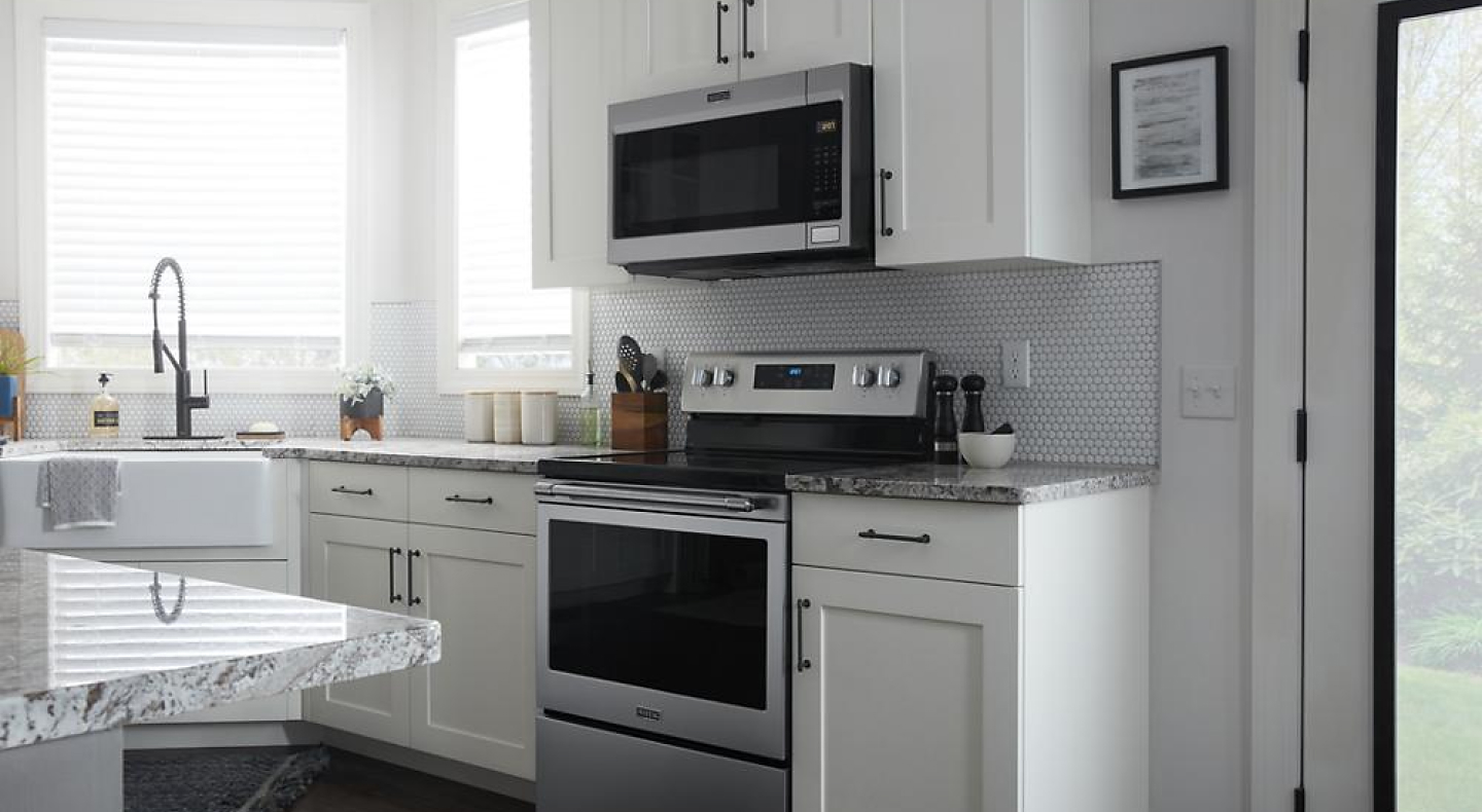 A Maytag® Over-the-Range Microwave installed above a Maytag® 30-Inch Wide Electric Range